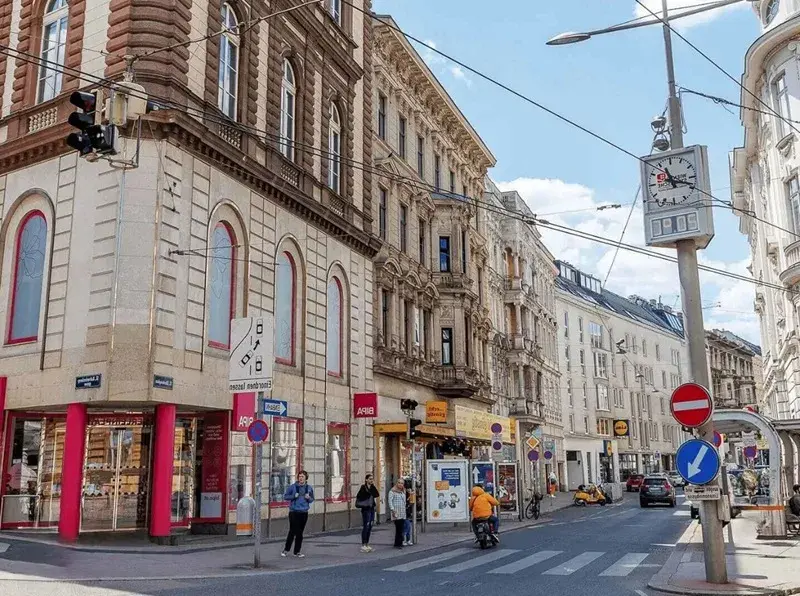 Street scene with historic buildings, local shops and tram infrastructure in Vienna's Hernals district